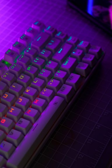 A close-up of a computer keyboard with vibrant multicoloured backlighting.